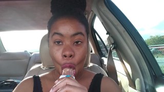 Ebony Big Lips Sucking Ice Cream Pop Outside In Car