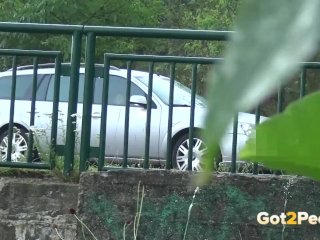 Pee Desperation - Redhead fires her piss stream through a railing in public