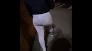 See through white leggings walking through city in public