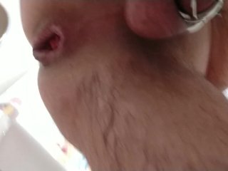 Anal masturbating with magic wand while caged