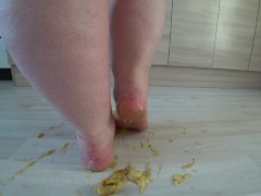 a big mature woman, bbw, smash a banana with bare feet, heels. crash trampl