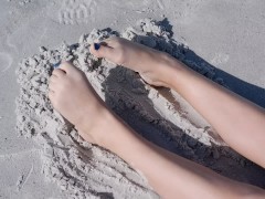 Sandy teen feet at the beach