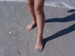 Wholesome teen getting her feet wet at the muddy beach