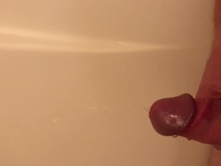 Guy pisses in the tub, then jerks himself off until he cums
