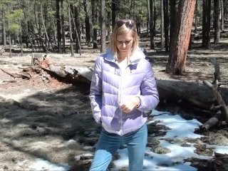 Girl is pissing in snow in the the winter forest very cold weather outside