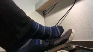 Male shoeplay in blue striped socks