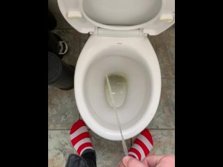 Pissing at home in red and white socks
