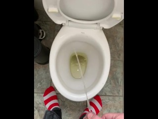 Pissing at home in red and white socks