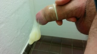 In A Public Toilet Filling A Condom With Cum