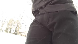 Public pissing black jeans and white briefs in a snowstorm