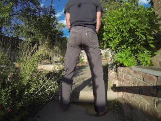 Pissing grey jeans in a huge flood outdoors