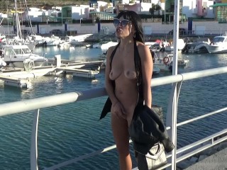 Hot blonde walks withoutpanties and strips naked at the seaport
