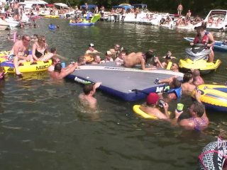 Hot Coed And MILF Play Naked On A Raft In Front Of Huge Crowd
