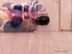 Self bondage in shiny spandex and swimsuit