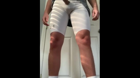 Football jock plays with dick through compression shorts hole