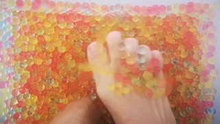 Feet playing in Orbeez