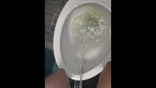 In A Public Bathroom A Messy Girl Stands Piss