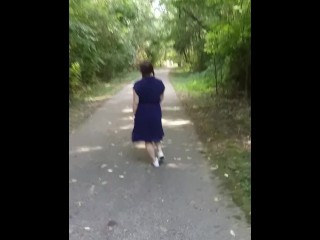 Cute girl with pigtails flashing in the park