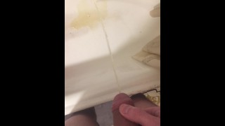 Russian guy pissing in the bath closeup