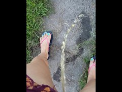 Girl Pees While Walking Down Public Sidewalk 