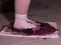 Plump legs in white socks mercilessly trample grapes. Crush fetish