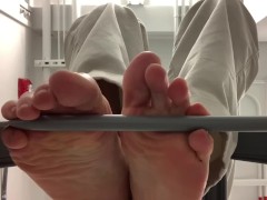 My bare soles from under a barstool 