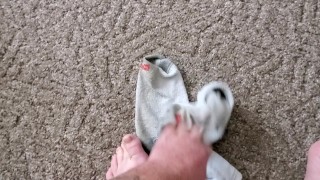 Takes sweaty, dirty work socks off and shows feet!