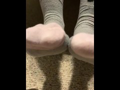 Ebony teen taking off sweaty shoes after class