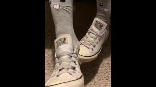 Ebony teen taking off sweaty shoes after class