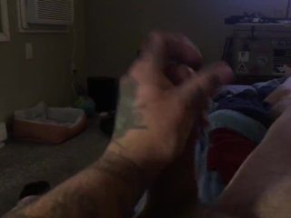 Tattooed guy stroking big cock till he cums