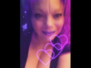 Blowing pink kisses.