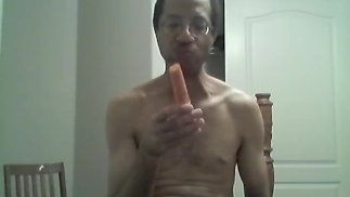 BLACK GAY STICKS CARROT IN ASS AND EATS IT