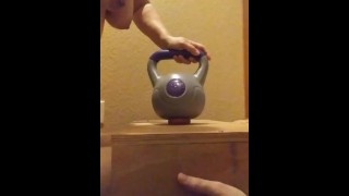 Wife crushes balls with kettle bells