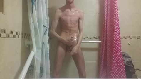 Hot very skinny guy with flat butt strokes his wet cock and pisses