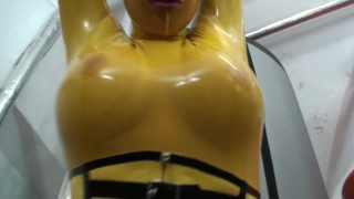 Girl Encased In Yellow Latex Catsuit Fishnets Bondages With Herself