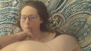 Hottie in glasses licks balls and gets cum on her face POV