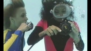 Beautiful Brunette And Blonde Submerged In A Swimming Pool While Scuba Diving PART 2