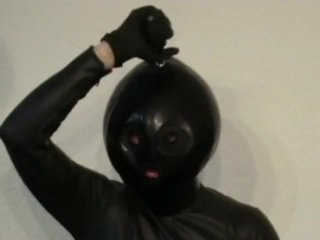 LatexCatsuit Girl With BlackRubber Ballhood Masturbates With Her Pussy