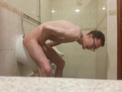 Very skinny teen masturbates in public bathroom urinal