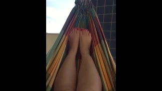 @tici_feet ig tici_feet rubbing my feet in my hammock, red toenails