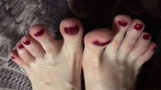 Red painted toenails close up