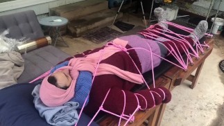 Wool mohair layers of sweaters on a bondage table 