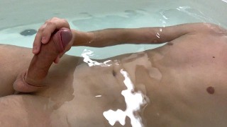 Boy is stroking his big cock in a bathtub until he cums!