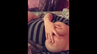Teen playing with tits in bed