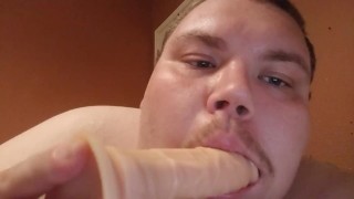 Fat man sucking a dildo