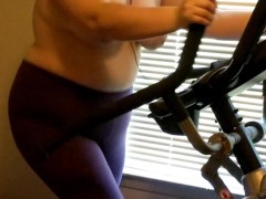 Wife exercising on elliptical topless 