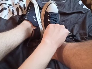 Beautiful legs in sneakers on the bed