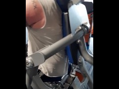 Tattooed muscular guy sweating in the gym 