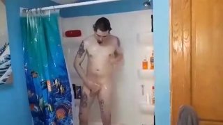 Young Tattooed Man Showering