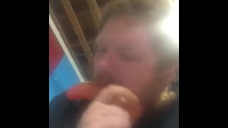 Fat guy sucking on dildo